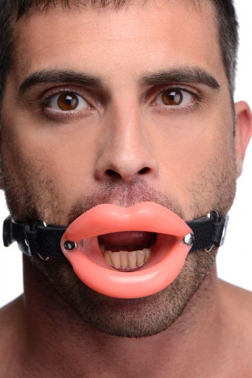 Man wearing a black muzzle with pink lips attached