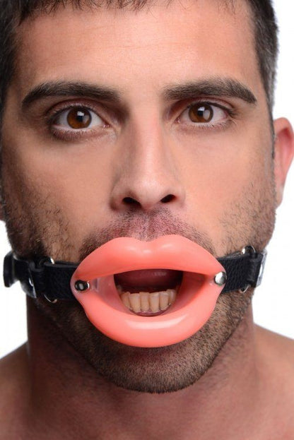 Man wearing a black muzzle with pink lips attached