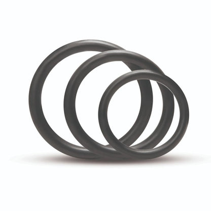 Three black rubber O-rings stacked on a white background