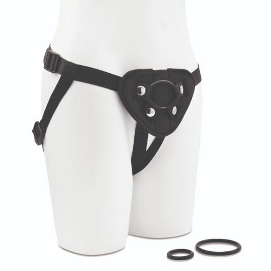 Black strap-on harness and rings on white body with a white background