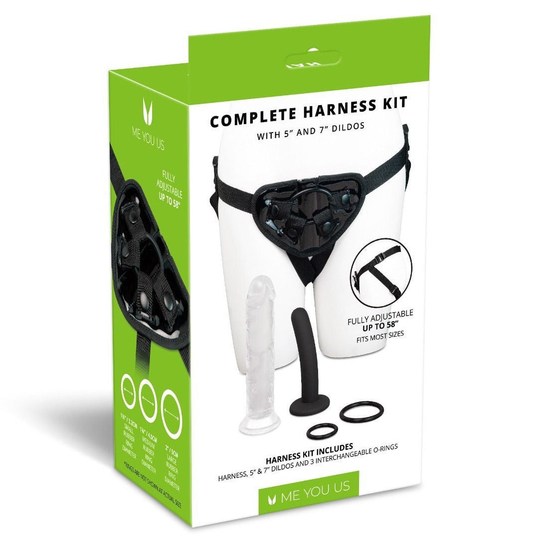 Boxed complete harness kit with dildos and adjustable harness, featuring green and white design.
