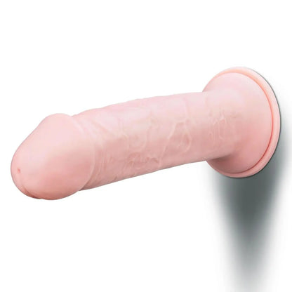 Pink silicone realistic dildo on a white background