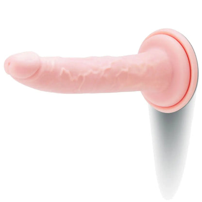 Pink silicone dildo on a white background