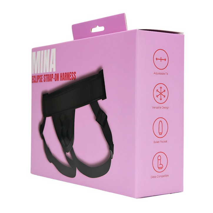 Pink packaging box with black strap-on harness on a white background
