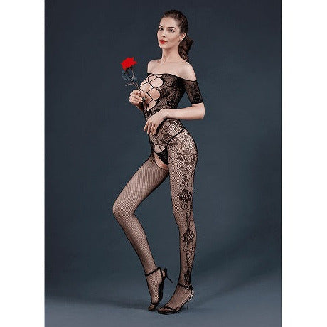 Woman wearing a black lace bodystocking holding a red rose against a dark background