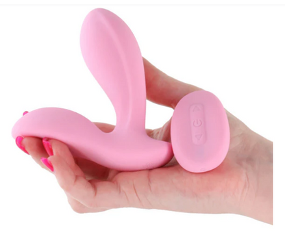 Pink silicone product held in a hand against a white background