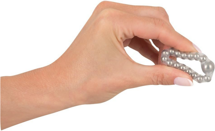 Hand holding a metallic ring with a white background