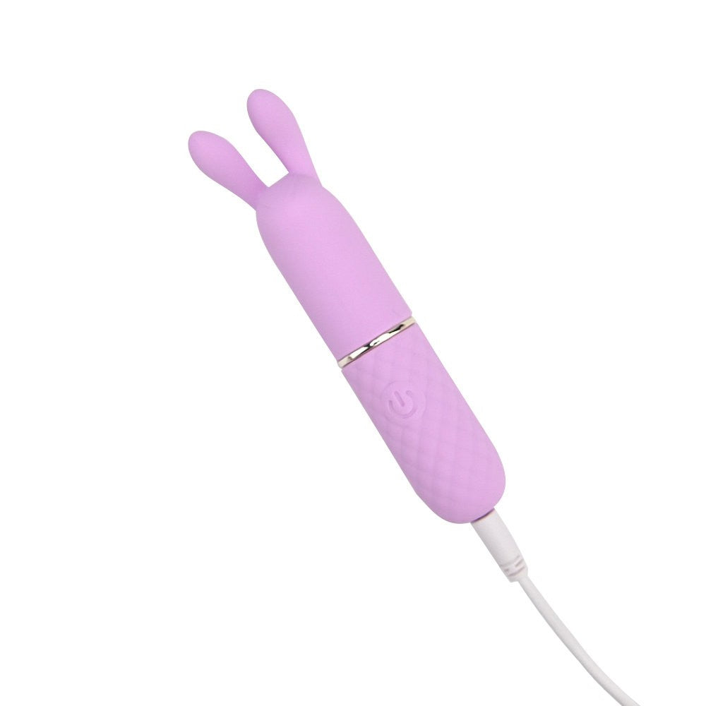 Pink rabbit-shaped electronic device on a white background