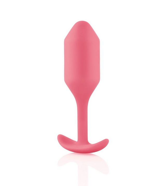 Coral silicone butt plug on a white background