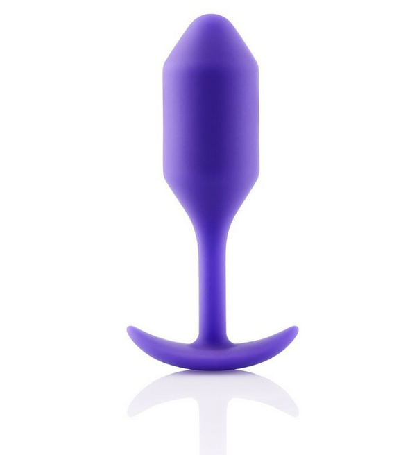 Purple silicone butt plug on a white background