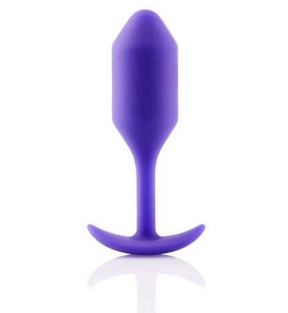 Purple silicone butt plug on a white background