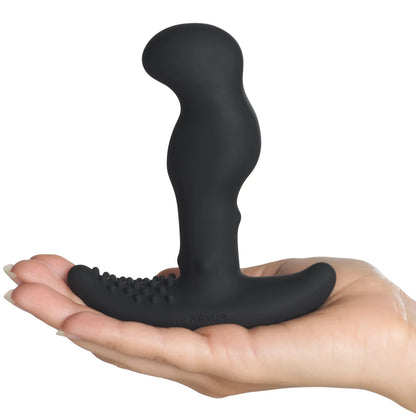 Black silicone butt plug held in a hand on a white background