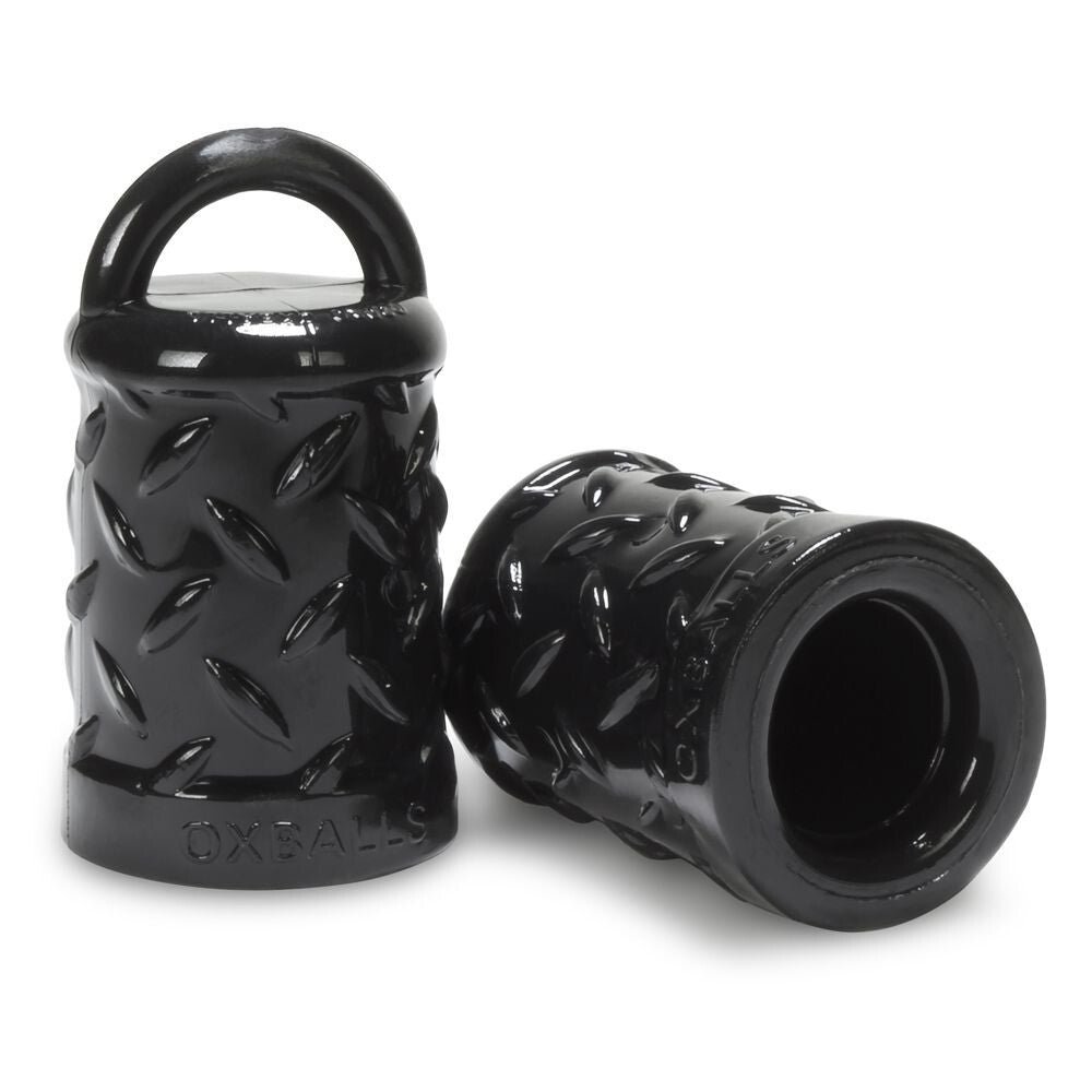 Black textured cylindrical nipple suckers with handle on a white background