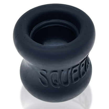 Black silicone cock ring testicle stretcher with 'SQUEEZE' branding on a white background