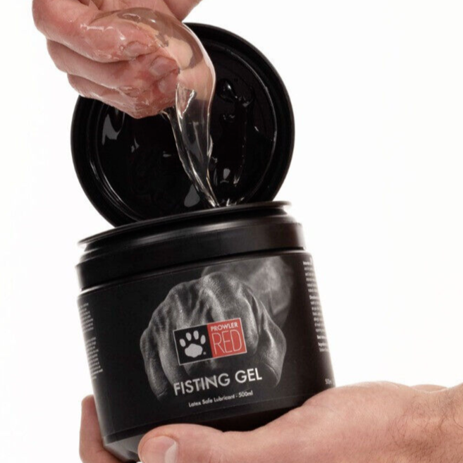 Person opening a container of Prowler Red Fisting Gel with a white background