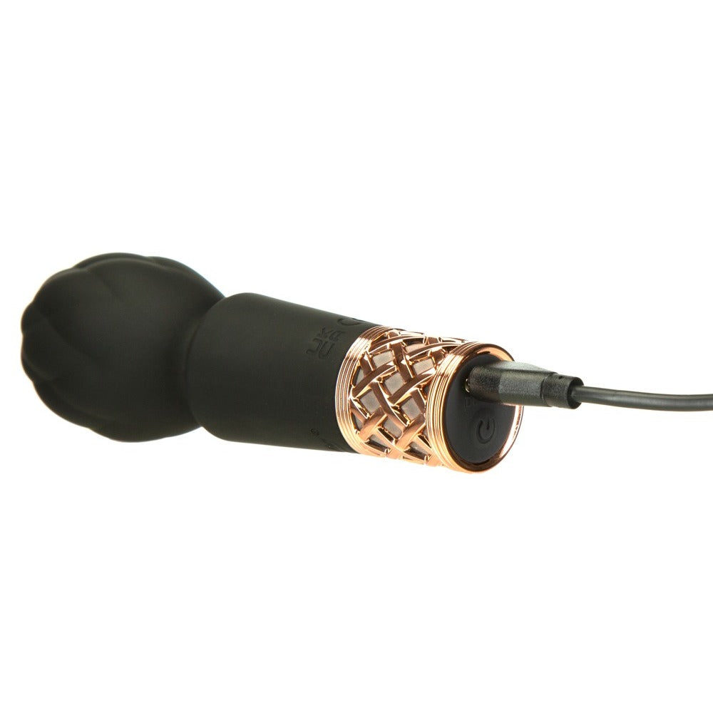 Black and rose gold massage wand on a white background