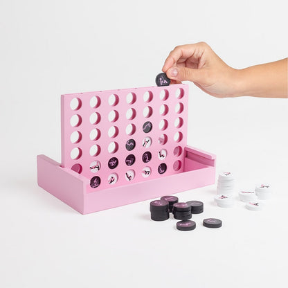 Pink connect four game with black and white discs on a light gray background