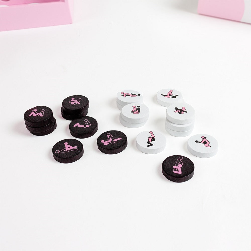 Black and white game pieces with pink illustrations on a white surface