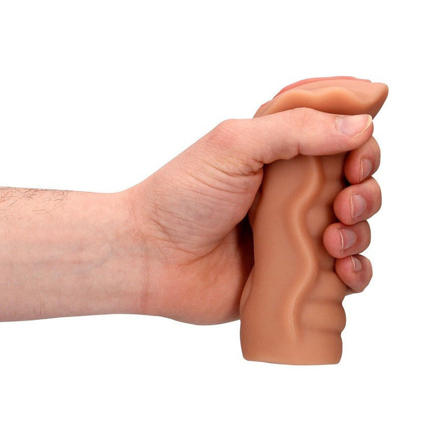 Hand holding a silicone masturbator on a white background