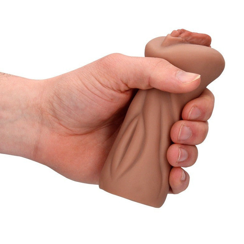 Hand holding a silicone masturbator toy on a white background
