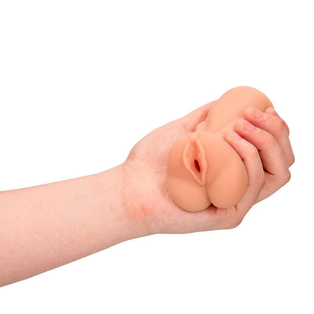 Hand holding a silicone realistic masturbator on a white background