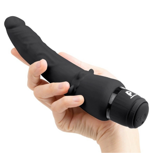 Black handheld vibrating dildo held in a hand on a white background