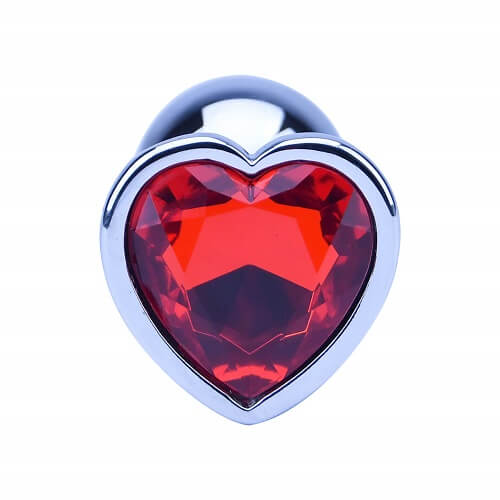 Heart-shaped object with a red gemstone and silver border on a white background