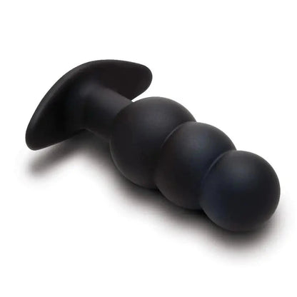 Black silicone butt plug on a white background