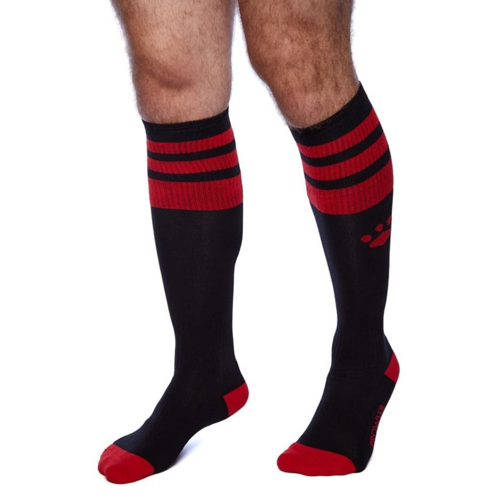 Black knee-high socks with red stripes and red toes on a white background