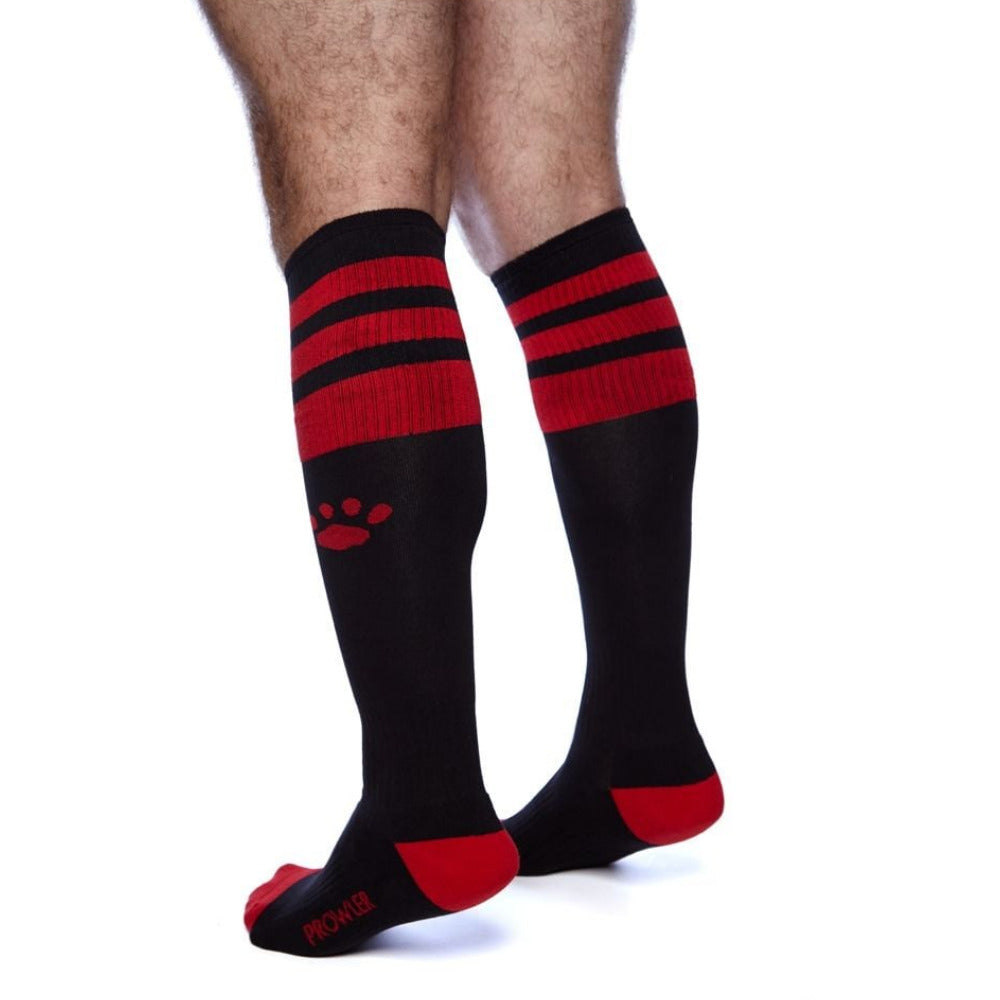 Black knee-high socks with red stripes and paw print on a white background