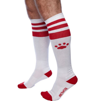 White knee-high socks with red stripes and paw print design on a white background