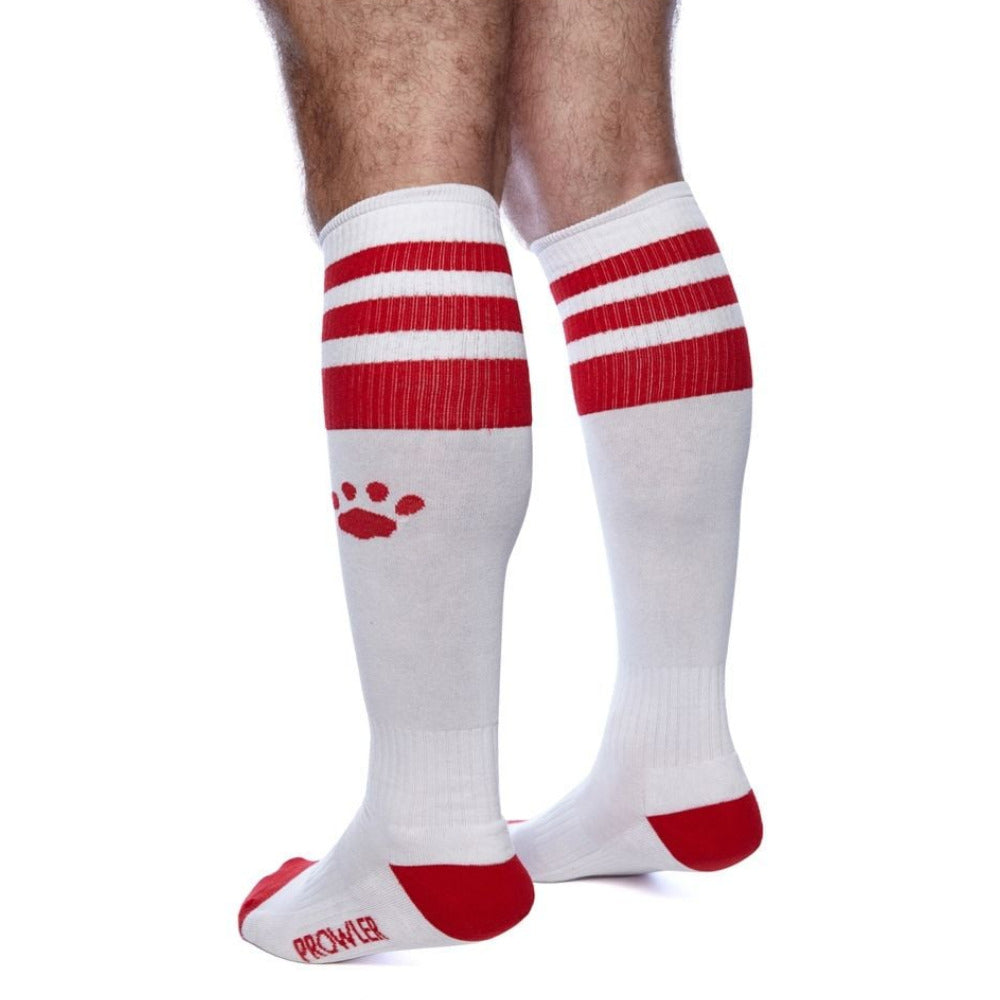 White knee-high socks with red stripes and paw print on a white background