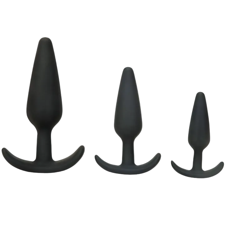 Three black silicone butt plugs of different sizes on a white background