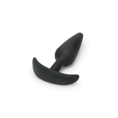 Black silicone butt plug on a white background