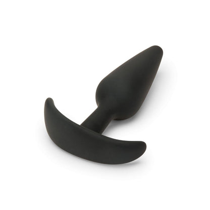 Black silicone butt plug on a white background