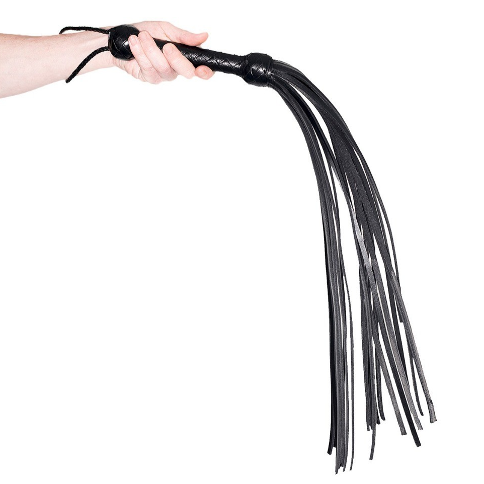 Black leather flogger held by a hand on a white background