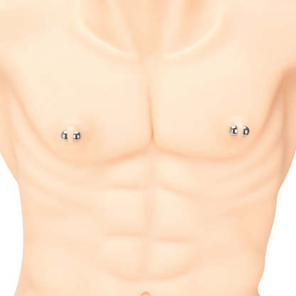 Close-up of a person wearing small magnetic nipple clamps on a plain background