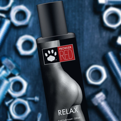 Bottle of Prowler Red Relax anal lubricant with product packaging on a blue background.