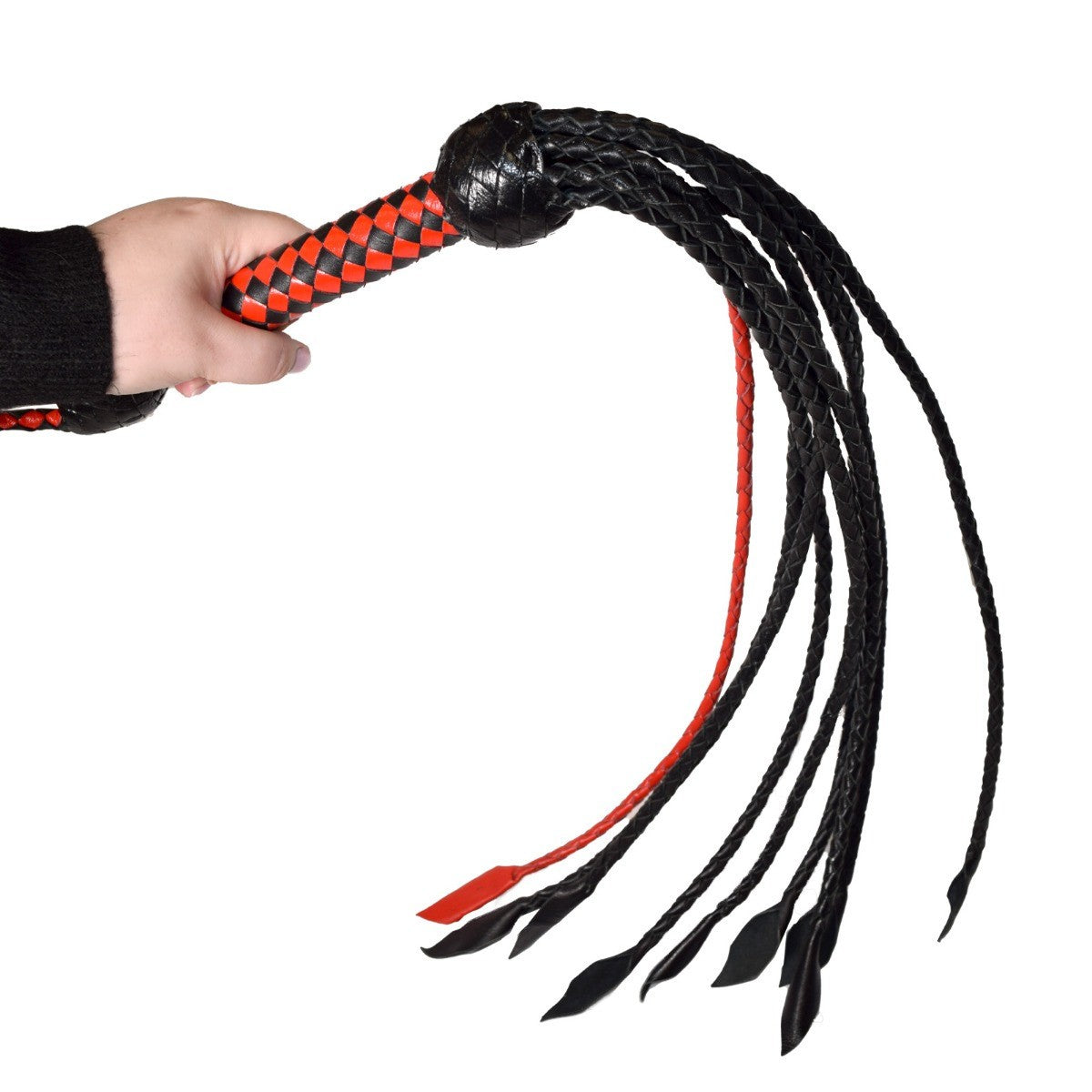 Hand holding a black and red leather whip against a white background