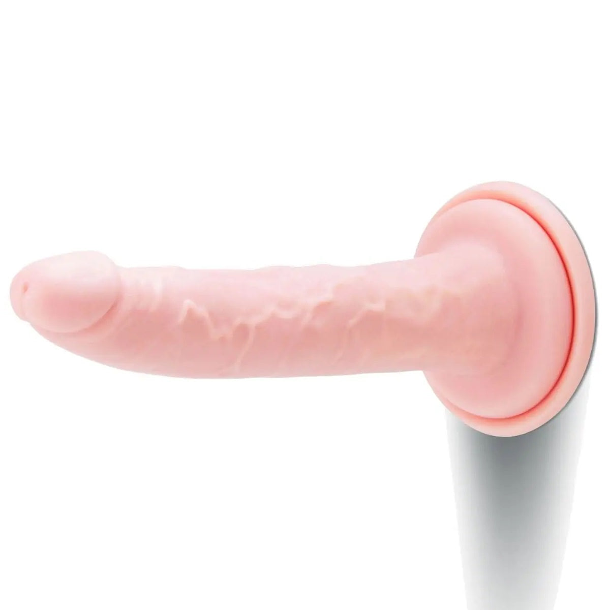 Pink silicone dildo on a white background