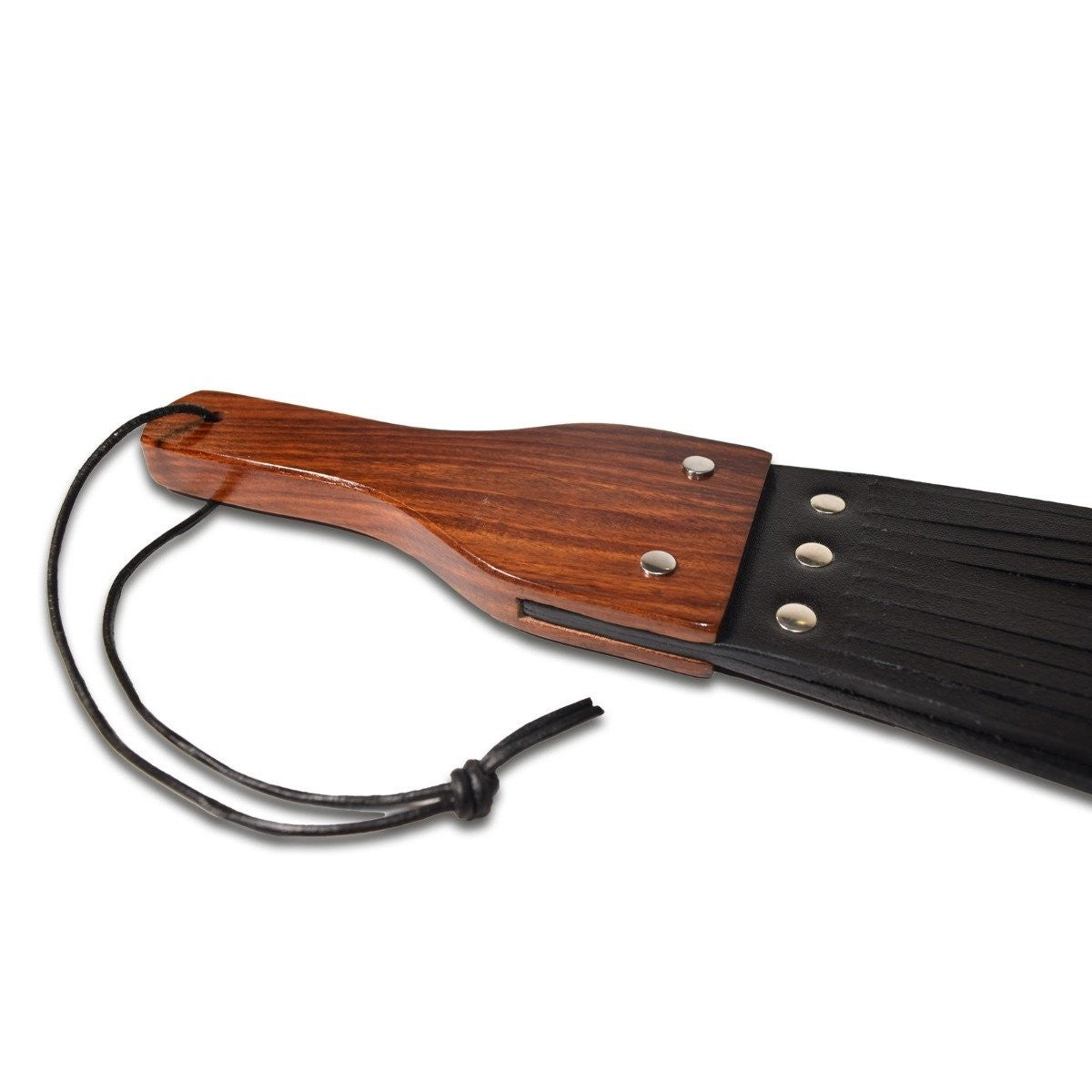 Wooden paddle with black leather strap on a white background