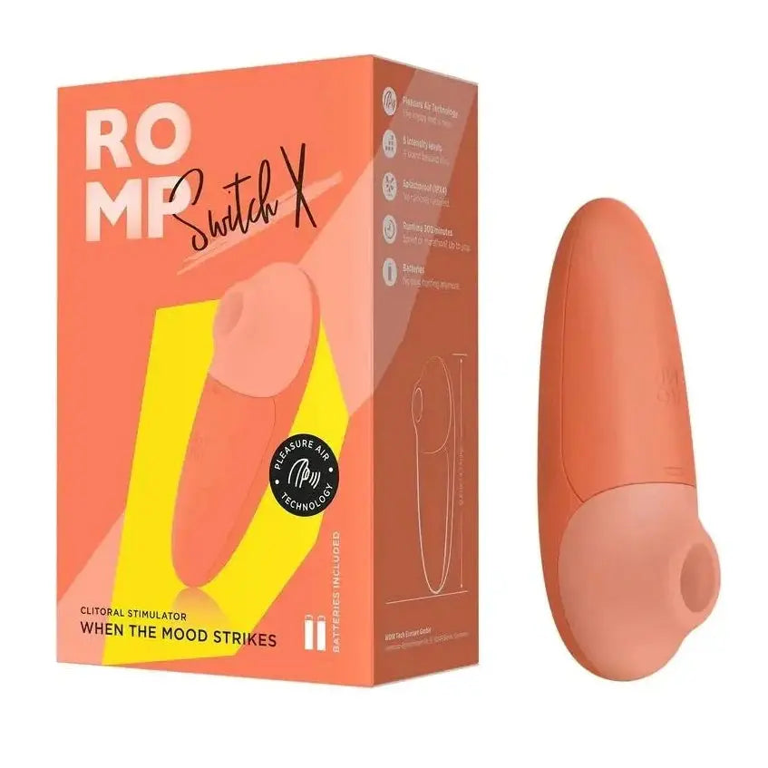Orange clitoral stimulator with packaging on a white background