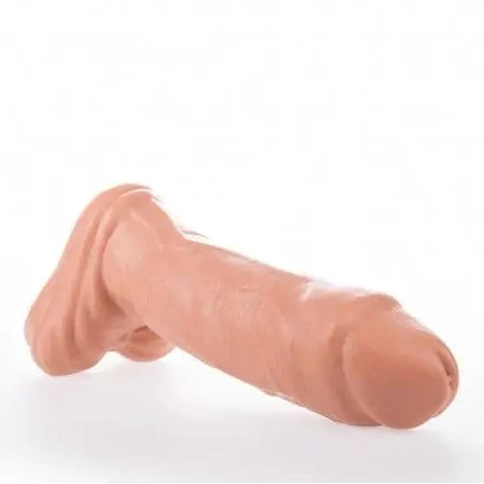 Realistic silicone model of a human penis on a white background
