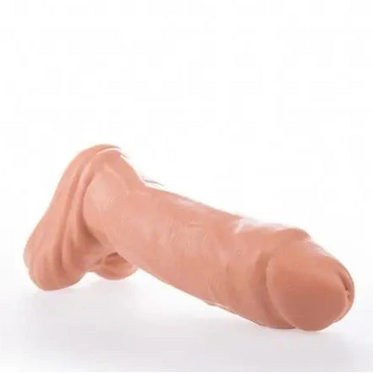 Realistic silicone model of a human penis on a white background