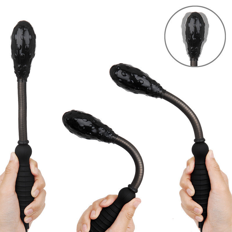 Black flexible wand massager held by hands with close-up inset on a white background