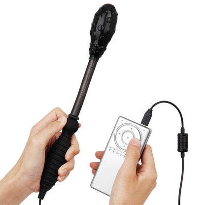Hand holding a black massage wand with a handheld controller on a white background