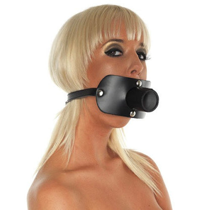 Person wearing a black leather muzzle on a white background
