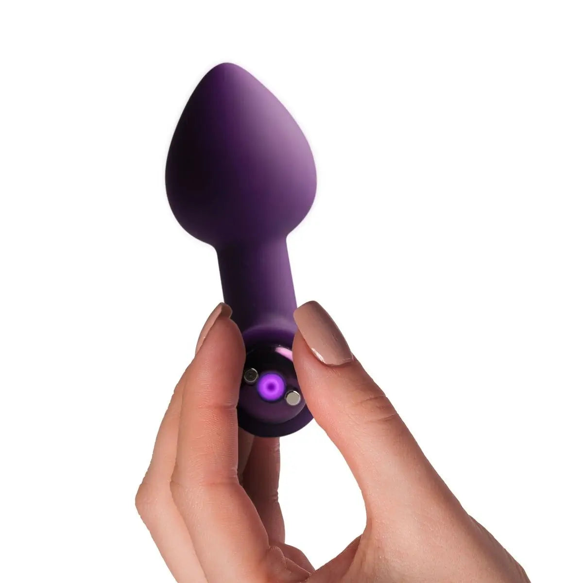 Purple handheld massager device held by a hand on a white background