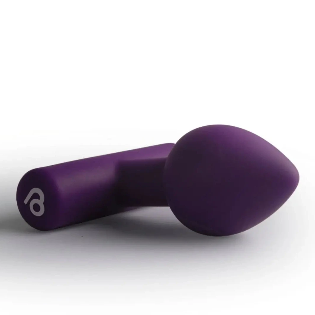 Purple anal plug vibrator on a white background