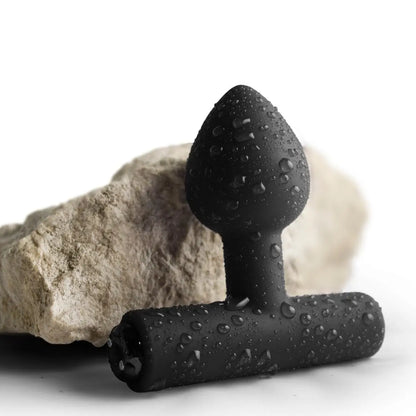 Black textured anal plug on a white background
